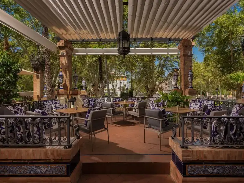 The hotel terrace, with tiled benches and tables under a pergola