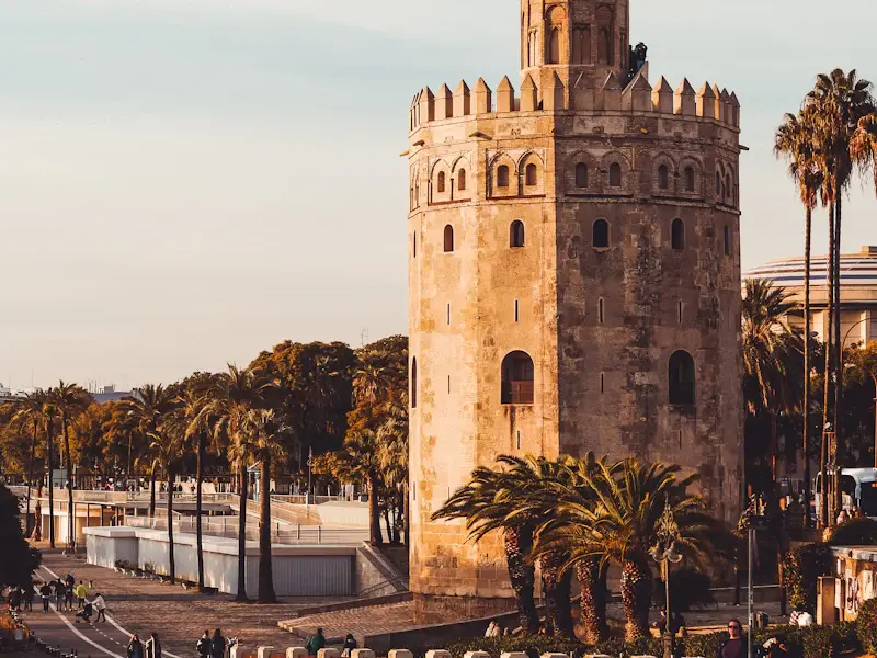 The Torre del Oro, a twelve-sided stone tower beside the river
