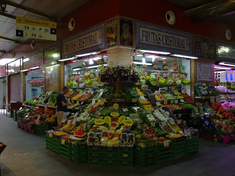 A fruit and vegetable stall inside the Triana market